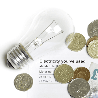 a lightbulb and money resting on an electricity bill